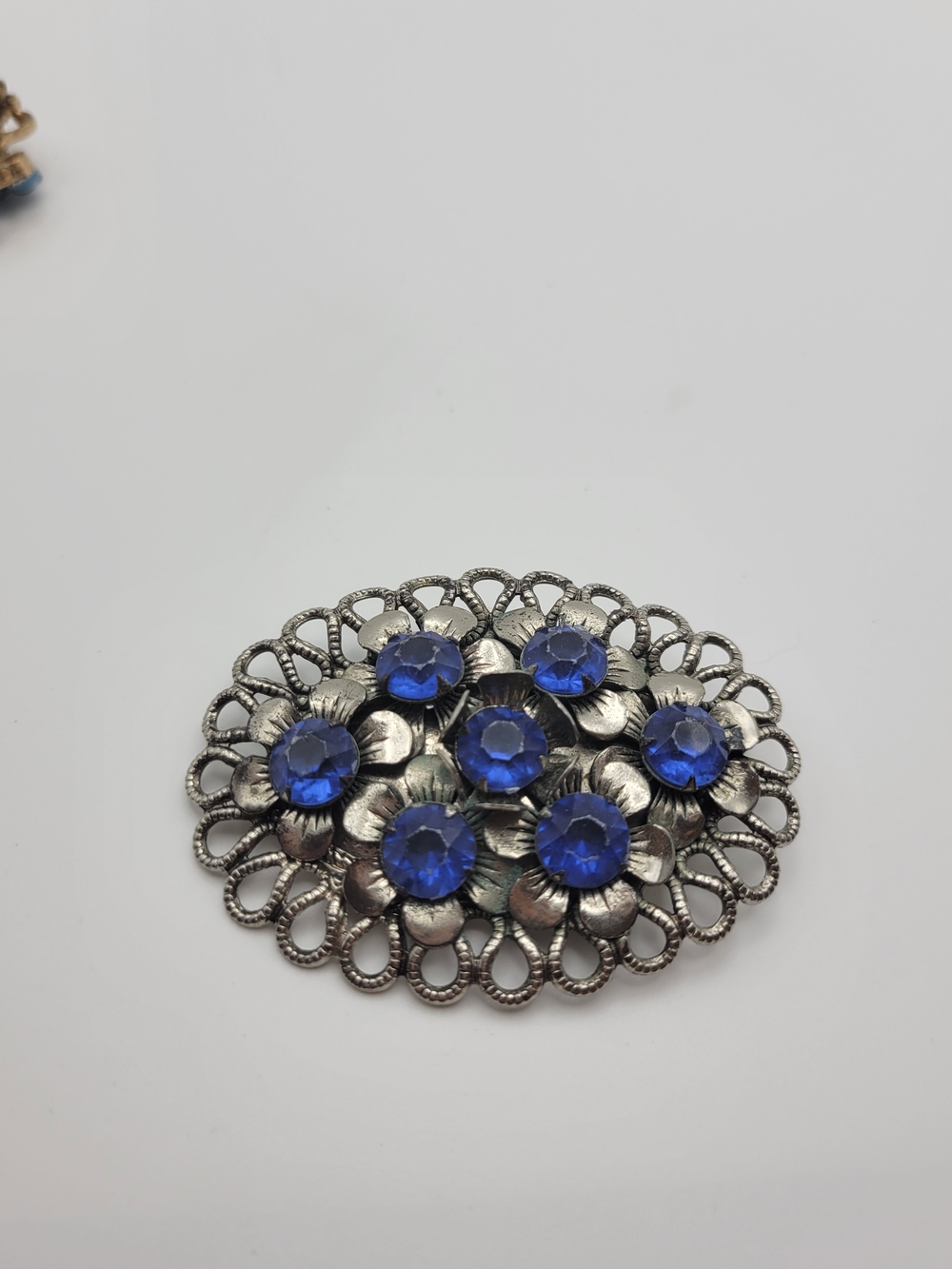 Vintage-Inspired Silver Floral Brooch with Blue Crystal Accents